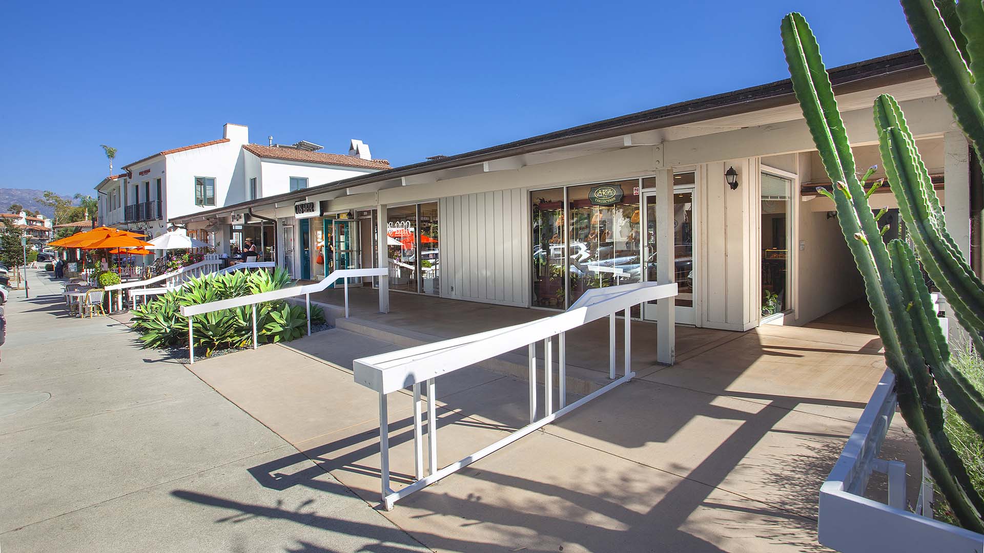 Coast Village Square building under sunny skies.
