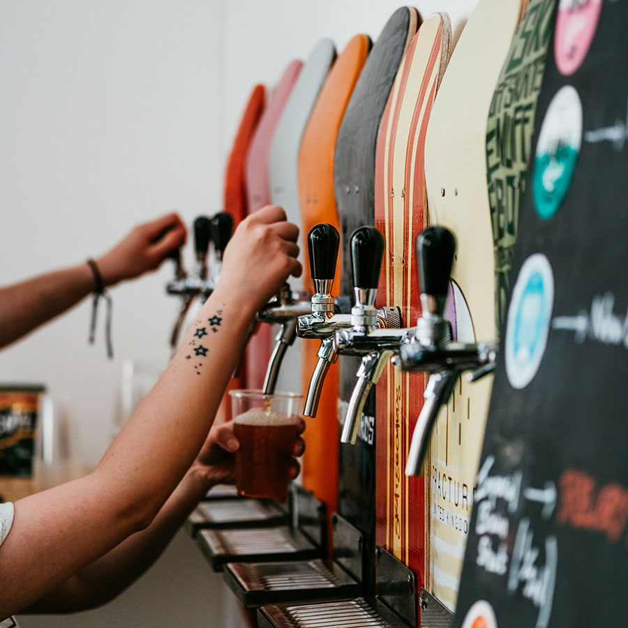 Brewery with taps decorated with skateboards.