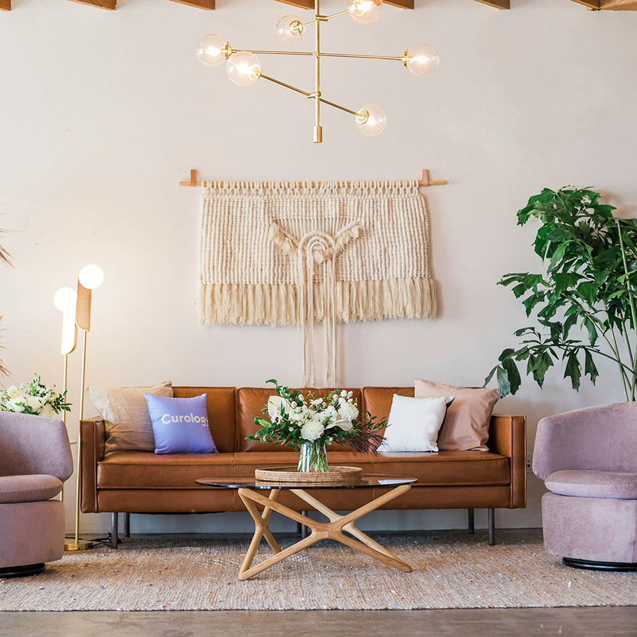 Living room with plush seating, eclectic decor, and brass light fixture.