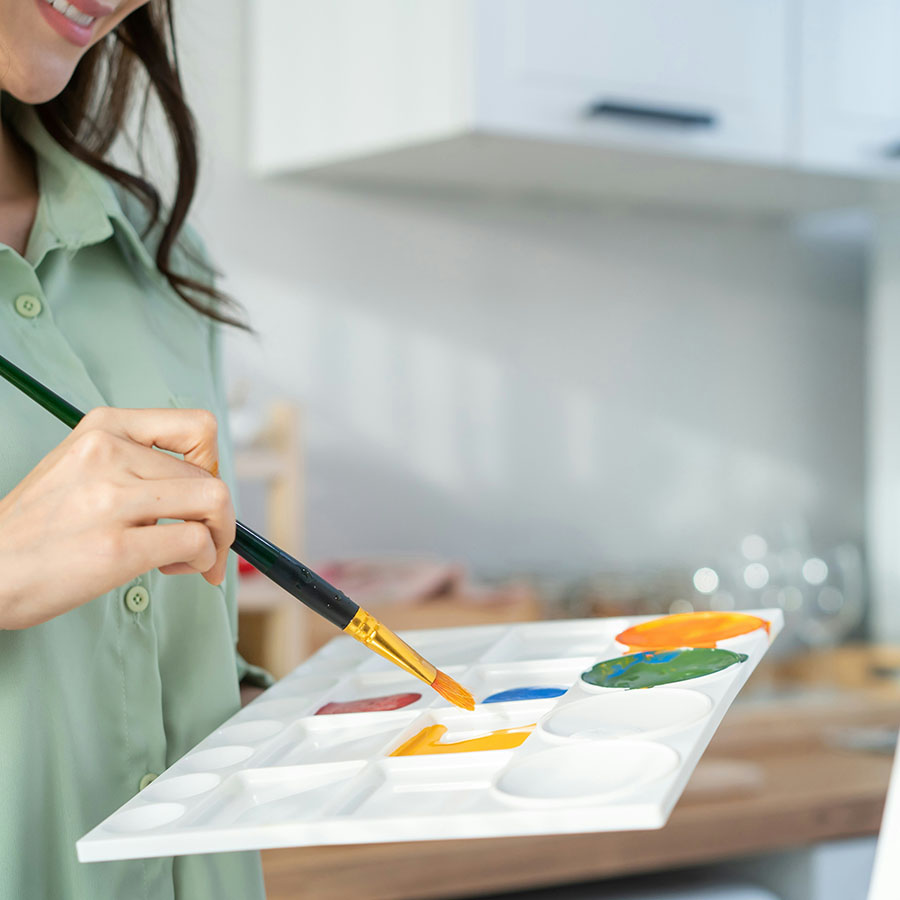 Person with palette and brush painting.