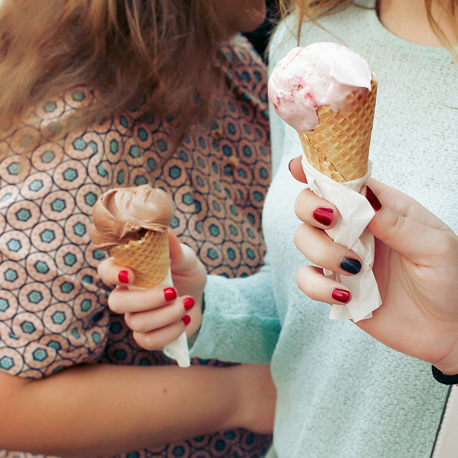 Friends eating ice cream cones together.