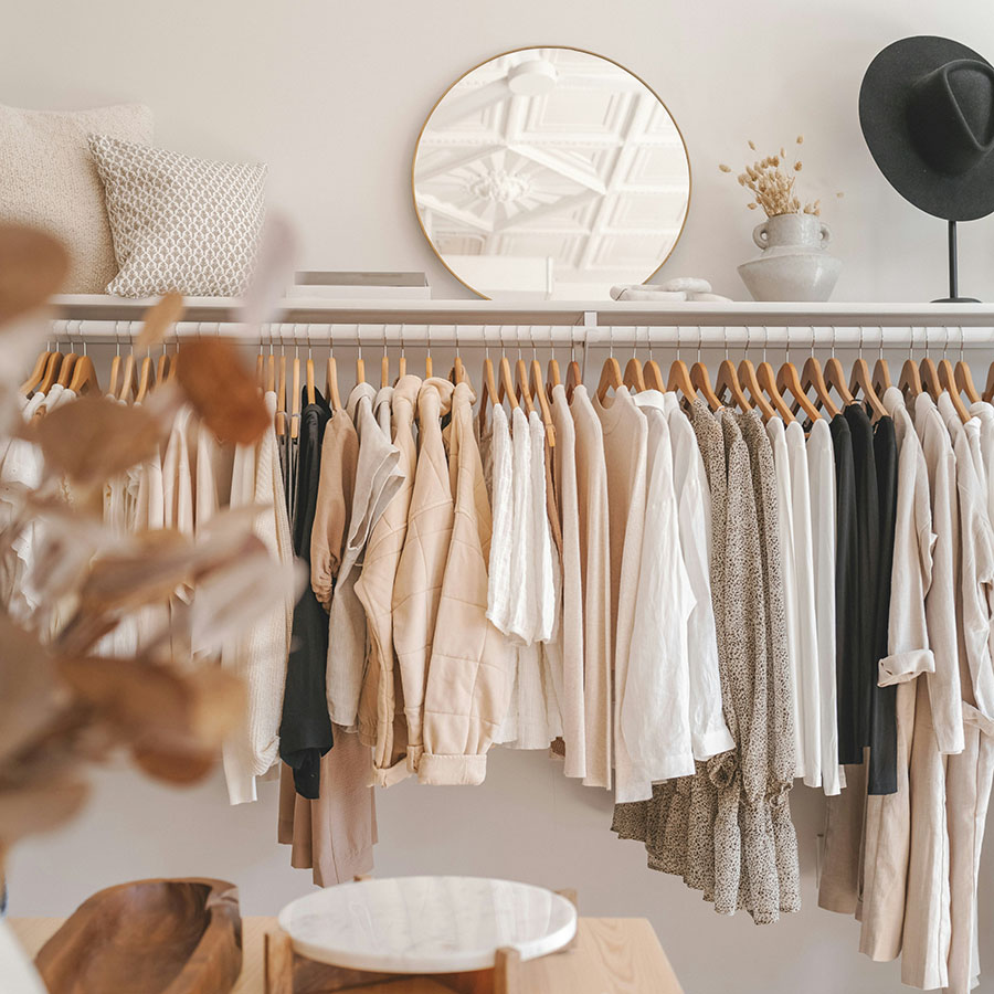 Airy boutique with racks of clothes and decor.