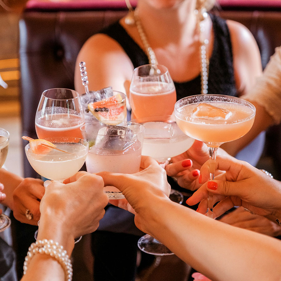 Friends toasting together with elegant cocktails.