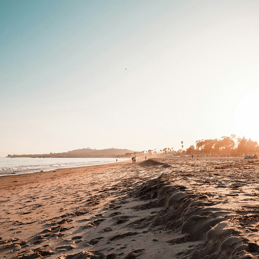 Sandy beach under bright morning sunshine.