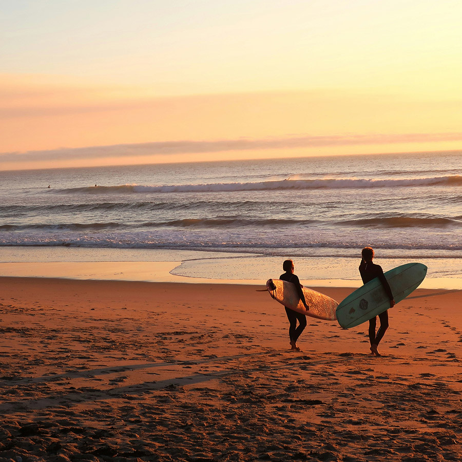 People surfing along the shores of Surf Beach.