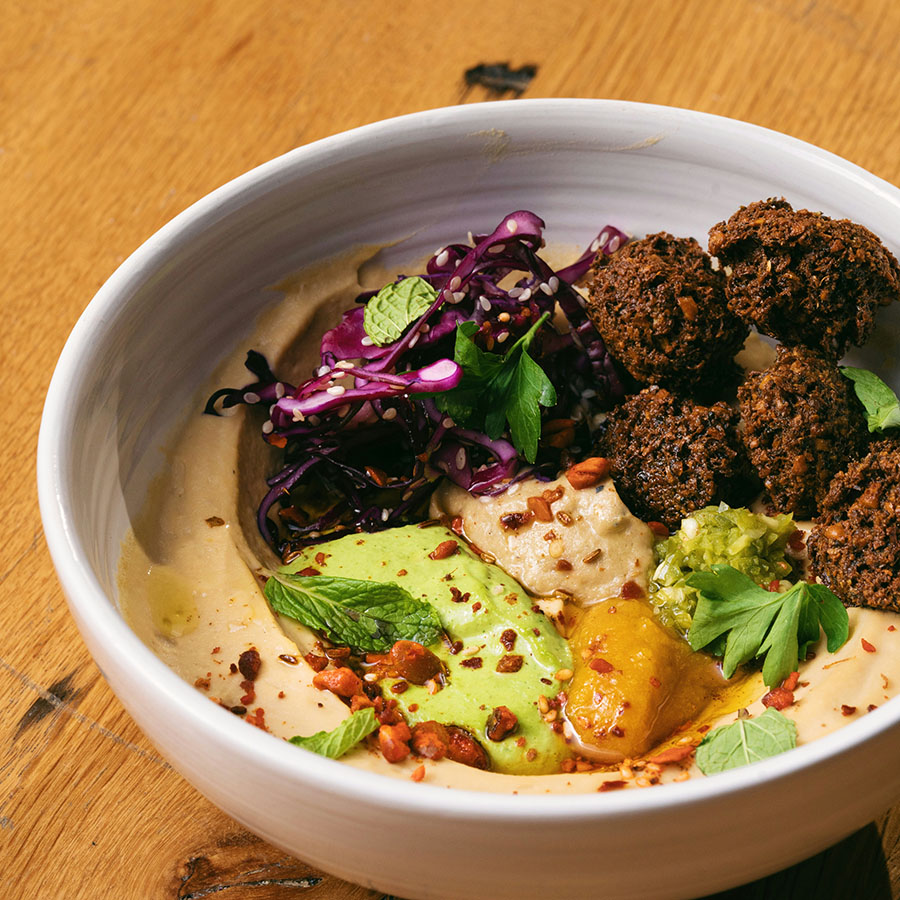 Mediterranean bowl with hummus, falafel, and vegetables.