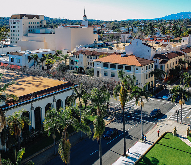 Aerial view of Santa Barbara with classic architecture and tall palm trees.